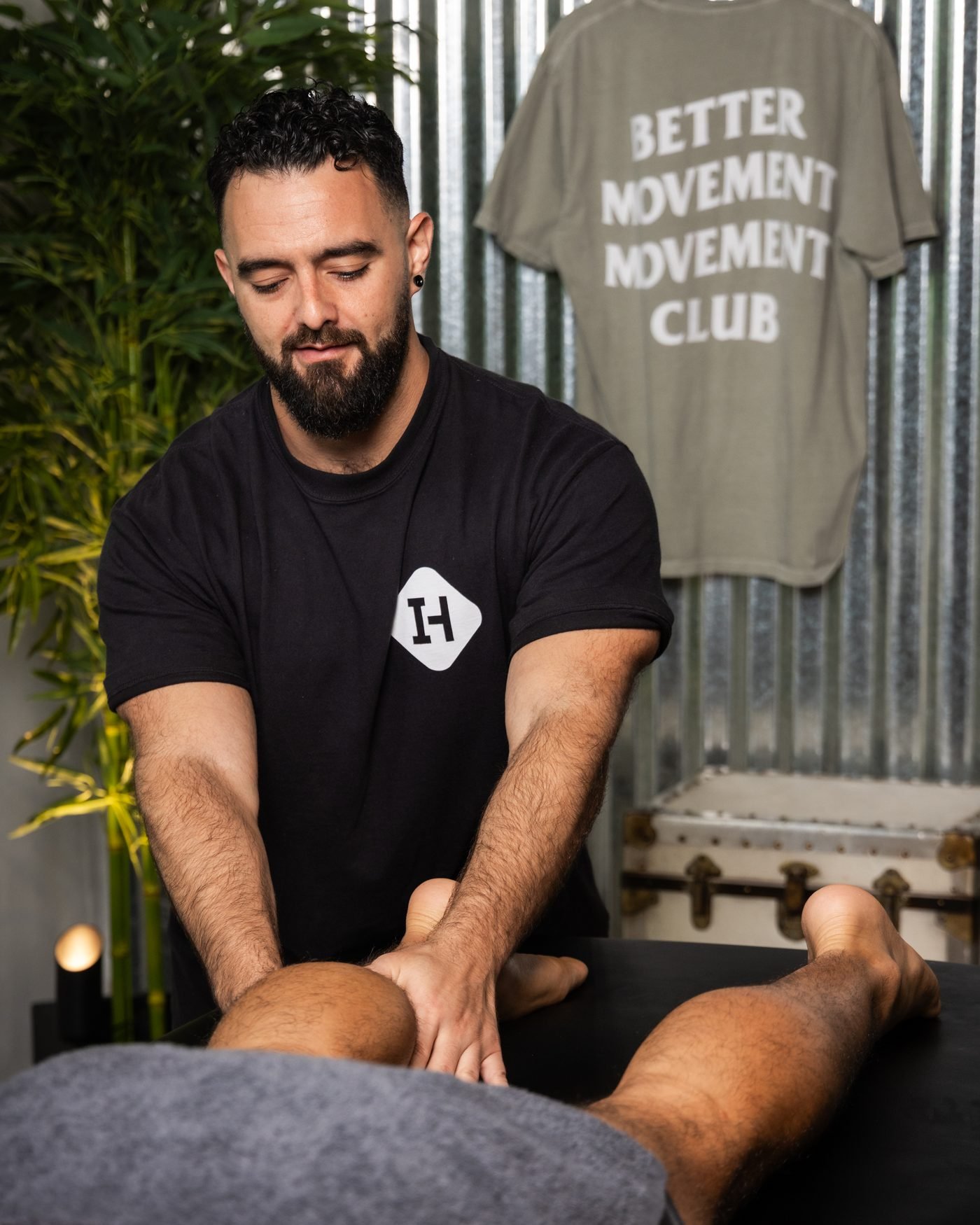 Daryl Duran, Licensed Massage Therapist, working on a patient’s lower leg during a Restore Session at the Wynwood studio